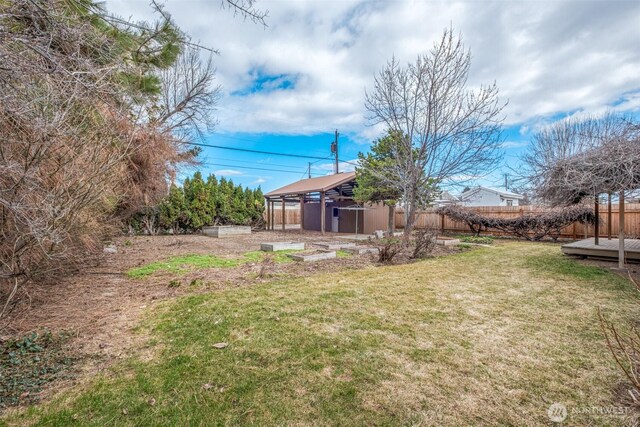 view of yard featuring an outdoor structure and fence private yard