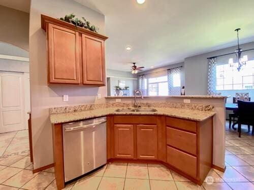 9500 SE Castlewood Dr, Moses Lake, WA 98837 - kitchen with stainless steel dishwasher, a sink, a chandelier, light tile patterned floors, and recessed lighting