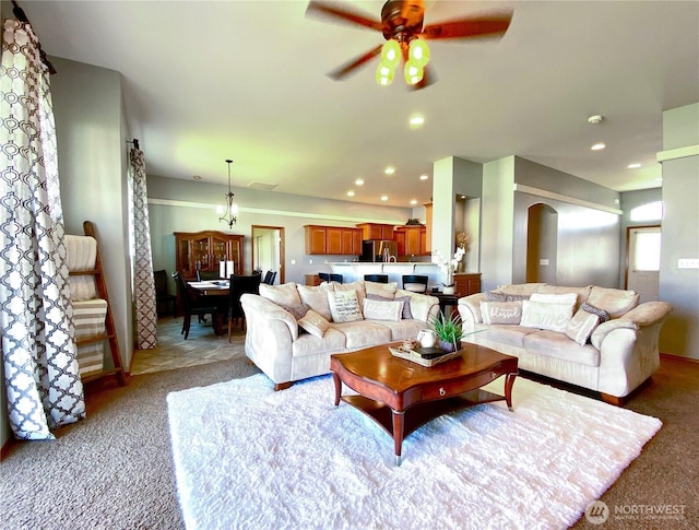 9500 SE Castlewood Dr, Moses Lake, WA 98837 - living room with light colored carpet, arched walkways, a ceiling fan, and recessed lighting