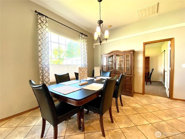 9500 SE Castlewood Dr, Moses Lake, WA 98837 - dining space featuring light tile patterned floors, a chandelier, and baseboards