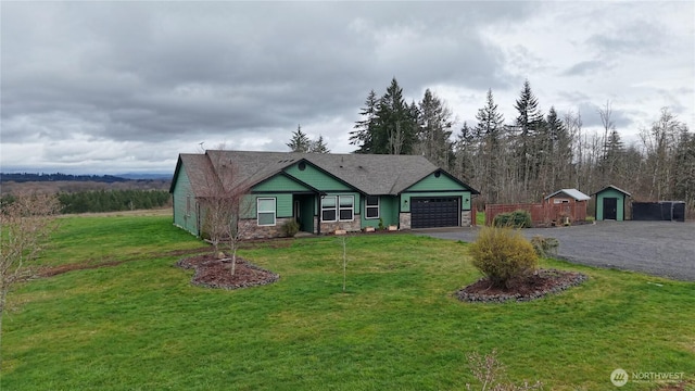 view of front of home featuring stone siding, driveway, a front lawn, and an attached garage