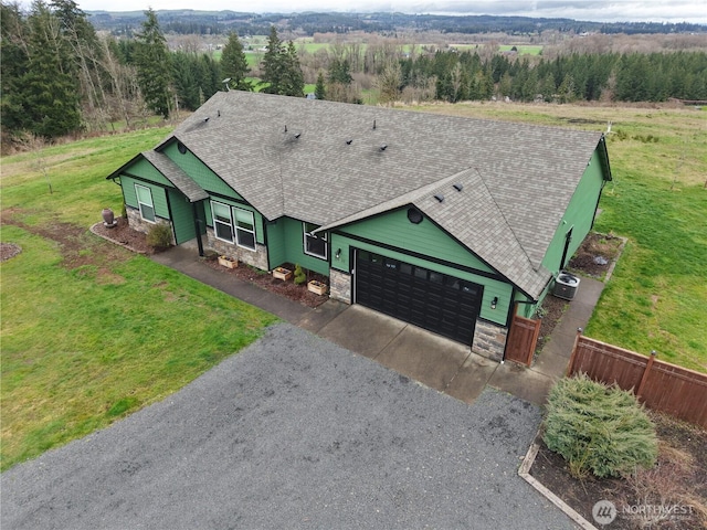 view of front of property with gravel driveway, cooling unit, stone siding, and a garage