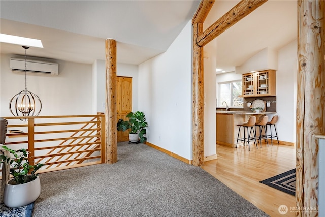 2932 Huntington St, Bellingham, WA 98226 - interior space featuring a wall mounted AC, baseboards, an inviting chandelier, a sink, and wood finished floors