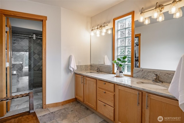 2932 Huntington St, Bellingham, WA 98226 - full bathroom featuring double vanity, a tile shower, baseboards, and a sink