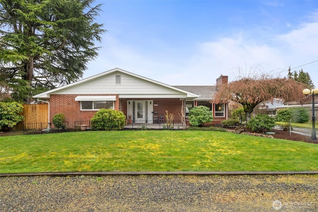 ranch-style home featuring brick siding, fence, a front lawn, and a chimney