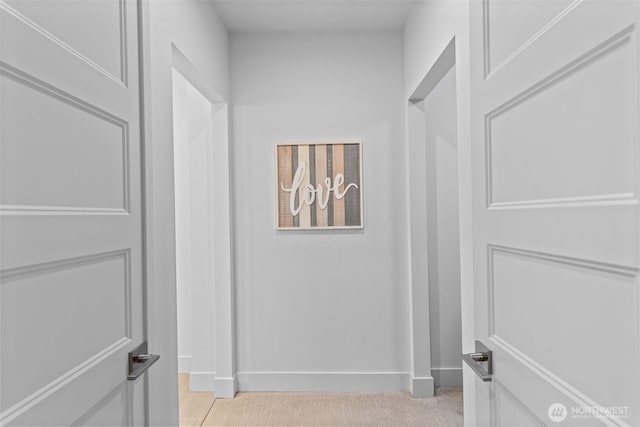 corridor featuring baseboards