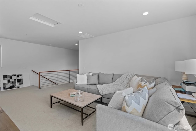 carpeted living area featuring attic access, visible vents, and recessed lighting
