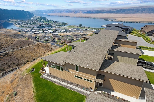 drone / aerial view with a water view and a residential view