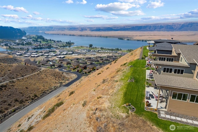 birds eye view of property with a water view