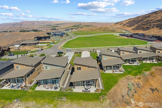 birds eye view of property with a mountain view and a residential view