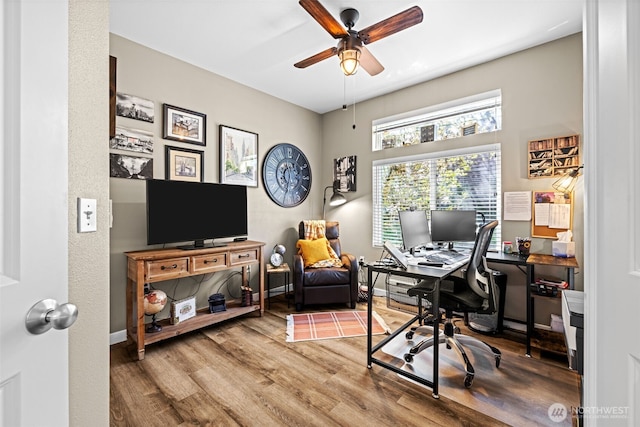 home office featuring ceiling fan, baseboards, and wood finished floors