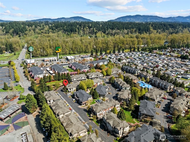 bird's eye view with a residential view, a view of trees, and a mountain view