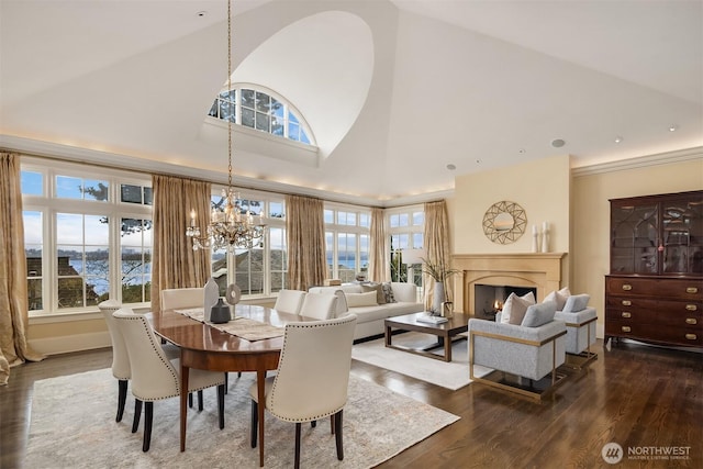 463 39th Ave E, Seattle, WA 98112 - dining room featuring high vaulted ceiling, dark wood-style flooring, a notable chandelier, and a lit fireplace