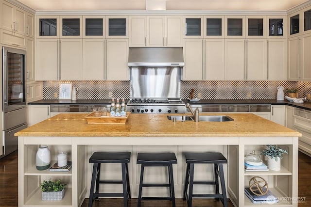 463 39th Ave E, Seattle, WA 98112 - kitchen with a kitchen island with sink, a sink, backsplash, open shelves, and under cabinet range hood
