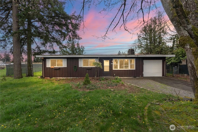 single story home featuring fence, an attached garage, board and batten siding, driveway, and a front lawn