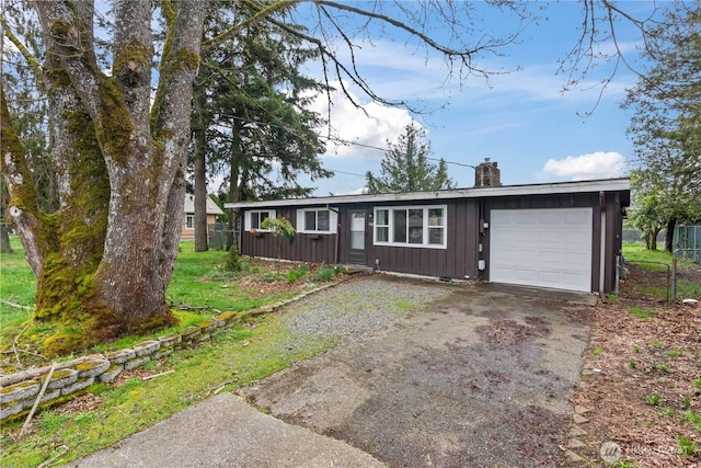 view of front facade featuring aphalt driveway, fence, an attached garage, a chimney, and board and batten siding