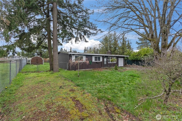 view of yard with a garage and fence
