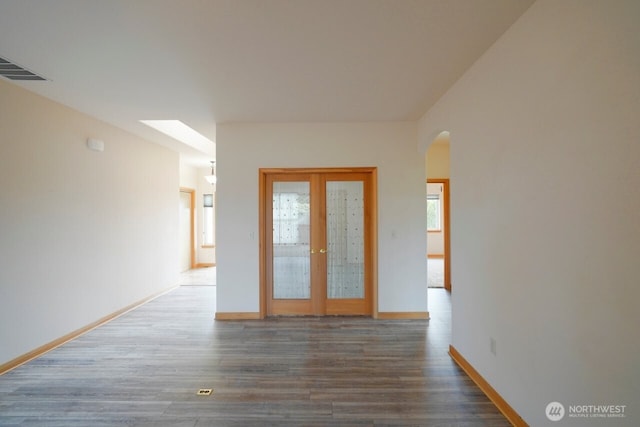 230 Choice Loop, Sequim, WA 98382 - spare room with arched walkways, wood finished floors, and french doors