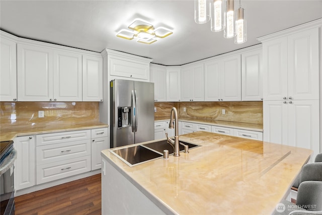 kitchen featuring light countertops, stainless steel appliances, dark wood finished floors, a sink, and white cabinets