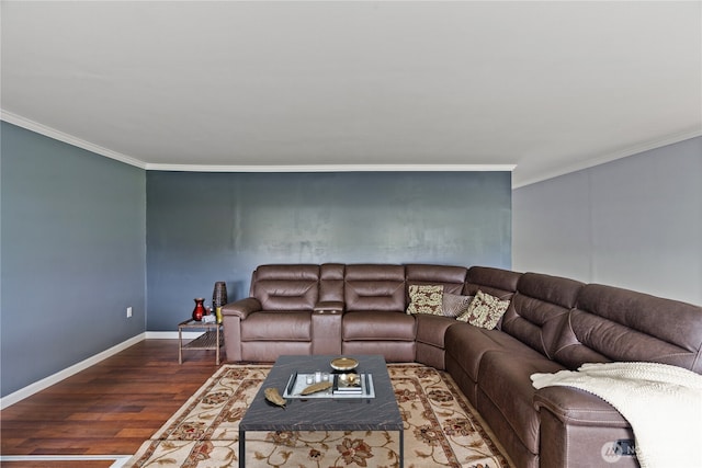 living area with baseboards, wood finished floors, and crown molding