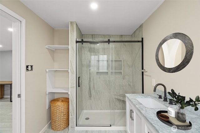 full bathroom featuring vanity, baseboards, and a shower stall