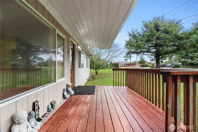 wooden deck featuring a yard