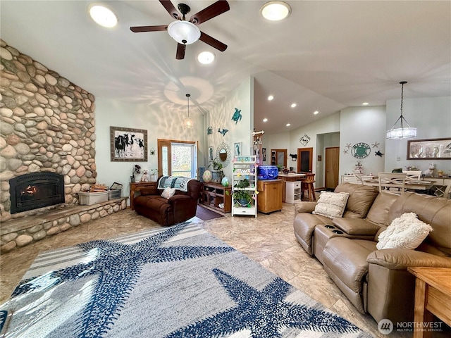 living room with a stone fireplace, lofted ceiling, and ceiling fan