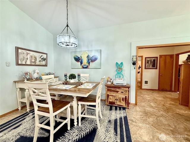 dining area with a notable chandelier and baseboards
