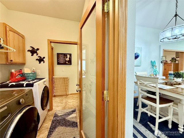 washroom featuring cabinet space and separate washer and dryer