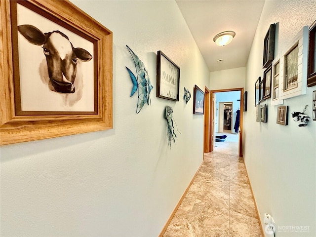 hallway featuring baseboards