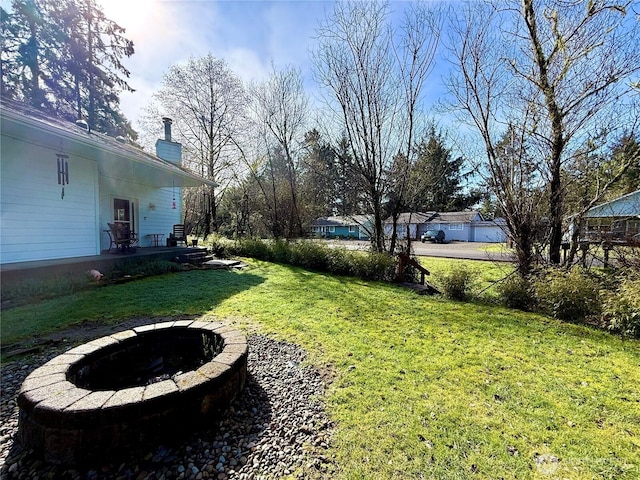 view of yard with a fire pit