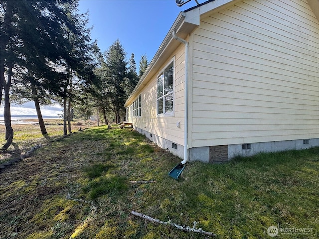 view of home's exterior with crawl space and a yard
