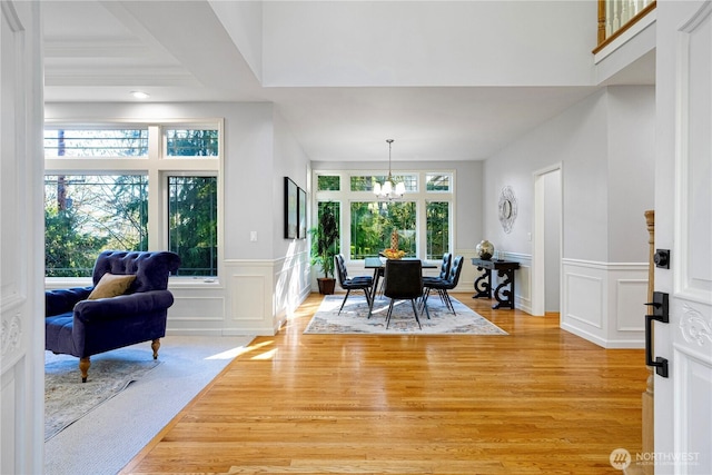 17955 SE 60th St, Bellevue, WA 98006 - foyer entrance with wainscoting, a decorative wall, a chandelier, and light wood-type flooring