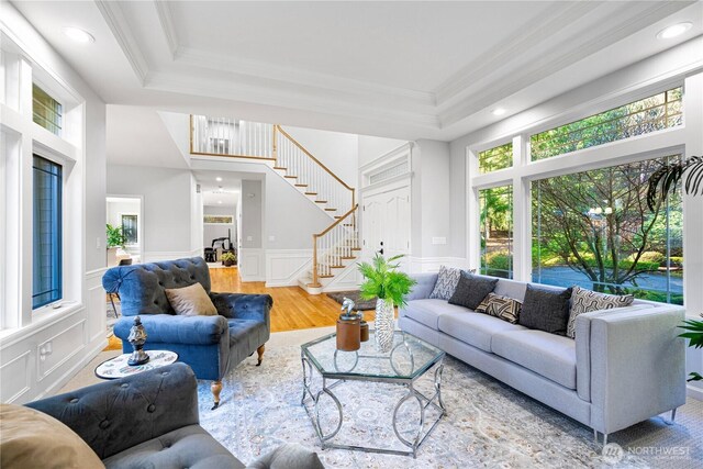 17955 SE 60th St, Bellevue, WA 98006 - living area featuring a decorative wall, crown molding, stairs, a tray ceiling, and wainscoting