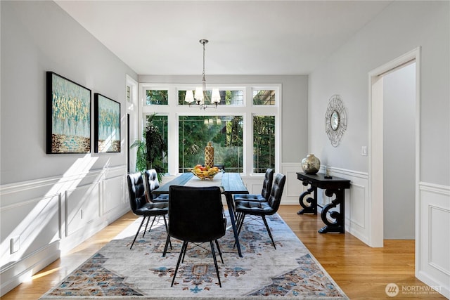 17955 SE 60th St, Bellevue, WA 98006 - dining room featuring a wainscoted wall, a decorative wall, a chandelier, and light wood-style floors