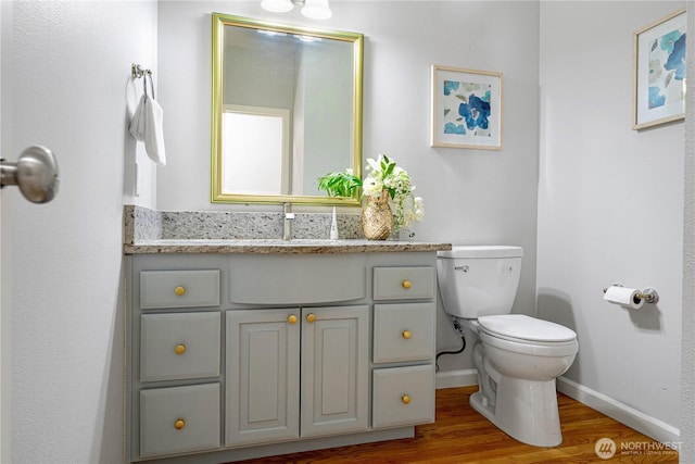17955 SE 60th St, Bellevue, WA 98006 - bathroom with toilet, vanity, baseboards, and wood finished floors
