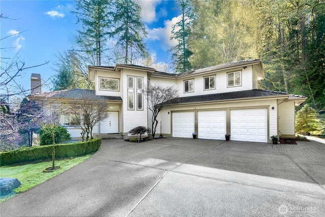 17955 SE 60th St, Bellevue, WA 98006 - view of front of house with an attached garage, a chimney, and concrete driveway