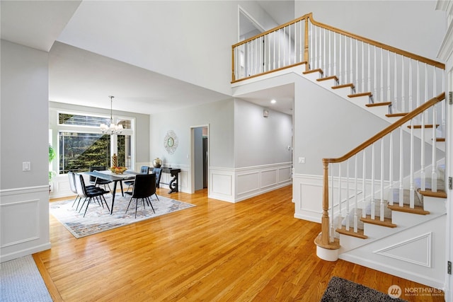 17955 SE 60th St, Bellevue, WA 98006 - stairs with a decorative wall, a towering ceiling, a chandelier, and wood finished floors