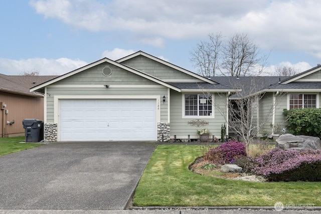 ranch-style home with a front yard, an attached garage, stone siding, and aphalt driveway