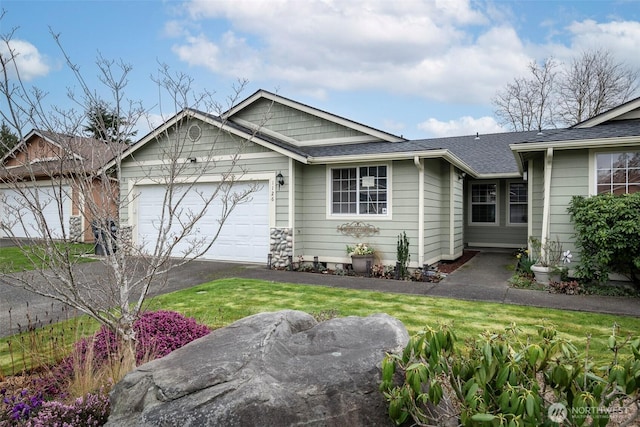 ranch-style home featuring driveway, an attached garage, and roof with shingles