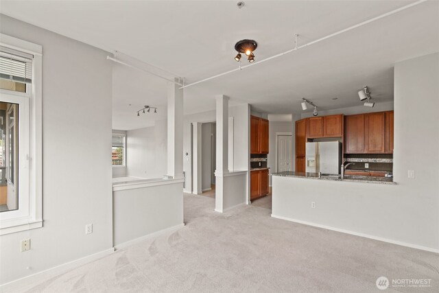 109 2nd St S Unit 337, Kirkland, WA 98033 - unfurnished living room with track lighting, baseboards, and light carpet