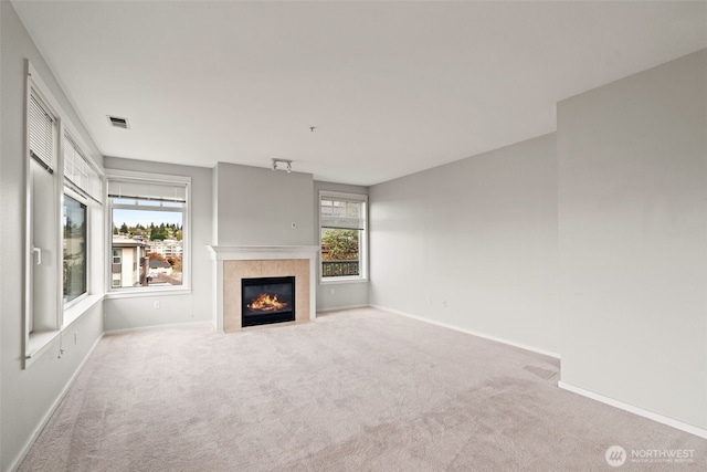 109 2nd St S Unit 337, Kirkland, WA 98033 - unfurnished living room featuring visible vents, baseboards, carpet, and a tile fireplace