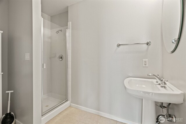 109 2nd St S Unit 337, Kirkland, WA 98033 - bathroom featuring a shower stall, tile patterned flooring, and baseboards
