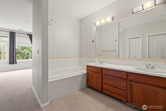 109 2nd St S Unit 337, Kirkland, WA 98033 - bathroom featuring a garden tub, double vanity, and a sink