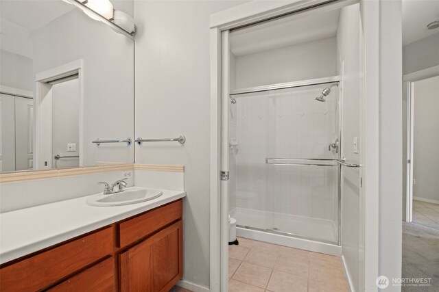 109 2nd St S Unit 337, Kirkland, WA 98033 - bathroom with a shower stall, tile patterned floors, vanity, and toilet
