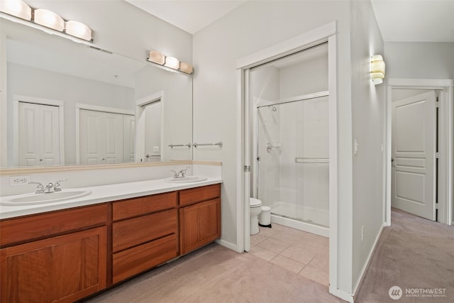 109 2nd St S Unit 337, Kirkland, WA 98033 - bathroom featuring baseboards, a sink, toilet, double vanity, and a stall shower