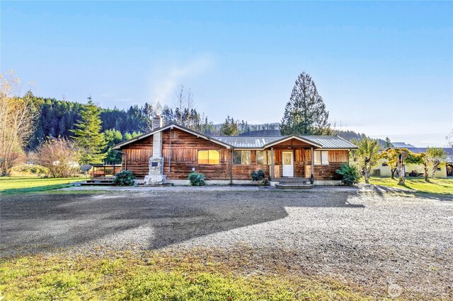 192 Meade Hill Rd, Glenoma, WA 98336 - view of front facade featuring metal roof, covered porch, and a chimney