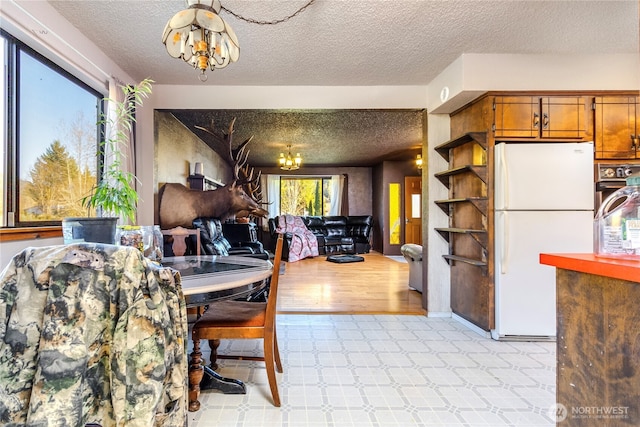 192 Meade Hill Rd, Glenoma, WA 98336 - dining area with a textured ceiling, a chandelier, and light floors
