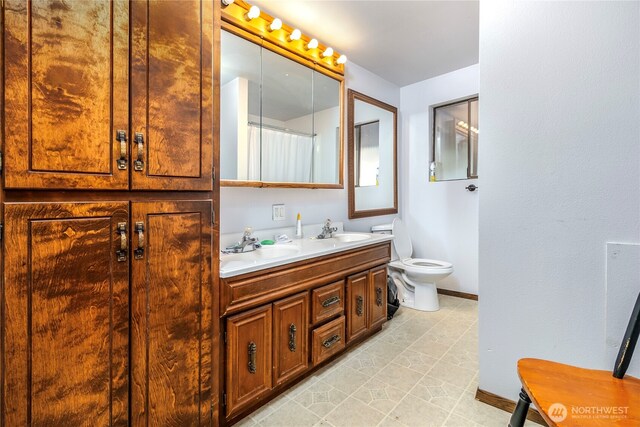 192 Meade Hill Rd, Glenoma, WA 98336 - full bathroom with toilet, a sink, double vanity, and baseboards