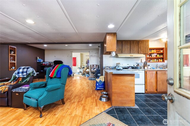 192 Meade Hill Rd, Glenoma, WA 98336 - kitchen with recessed lighting, under cabinet range hood, electric stove, a sink, and brown cabinets